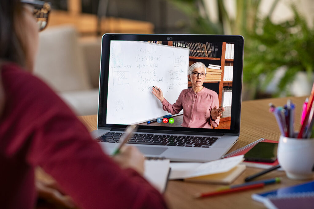 A student taking part in a live online lesson on a laptop at home