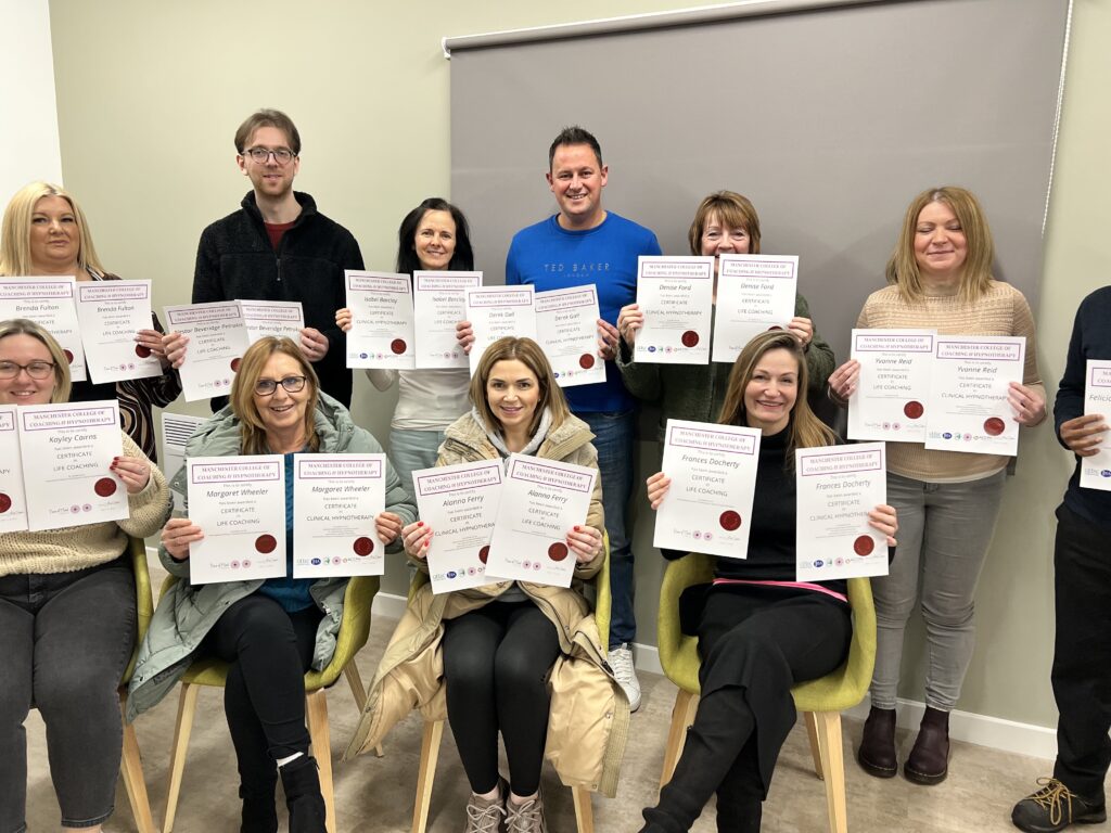 A group of Piece of Mind hypnotherapy graduates holding their certificates in Glasgow