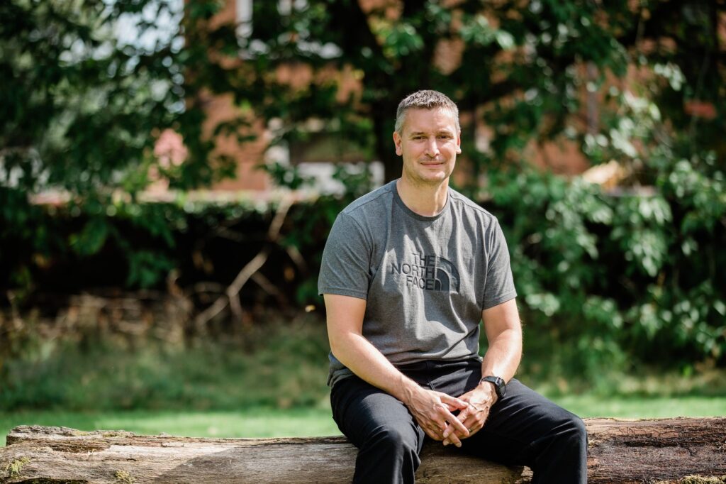 Andy Griffiths sitting outdoors among trees