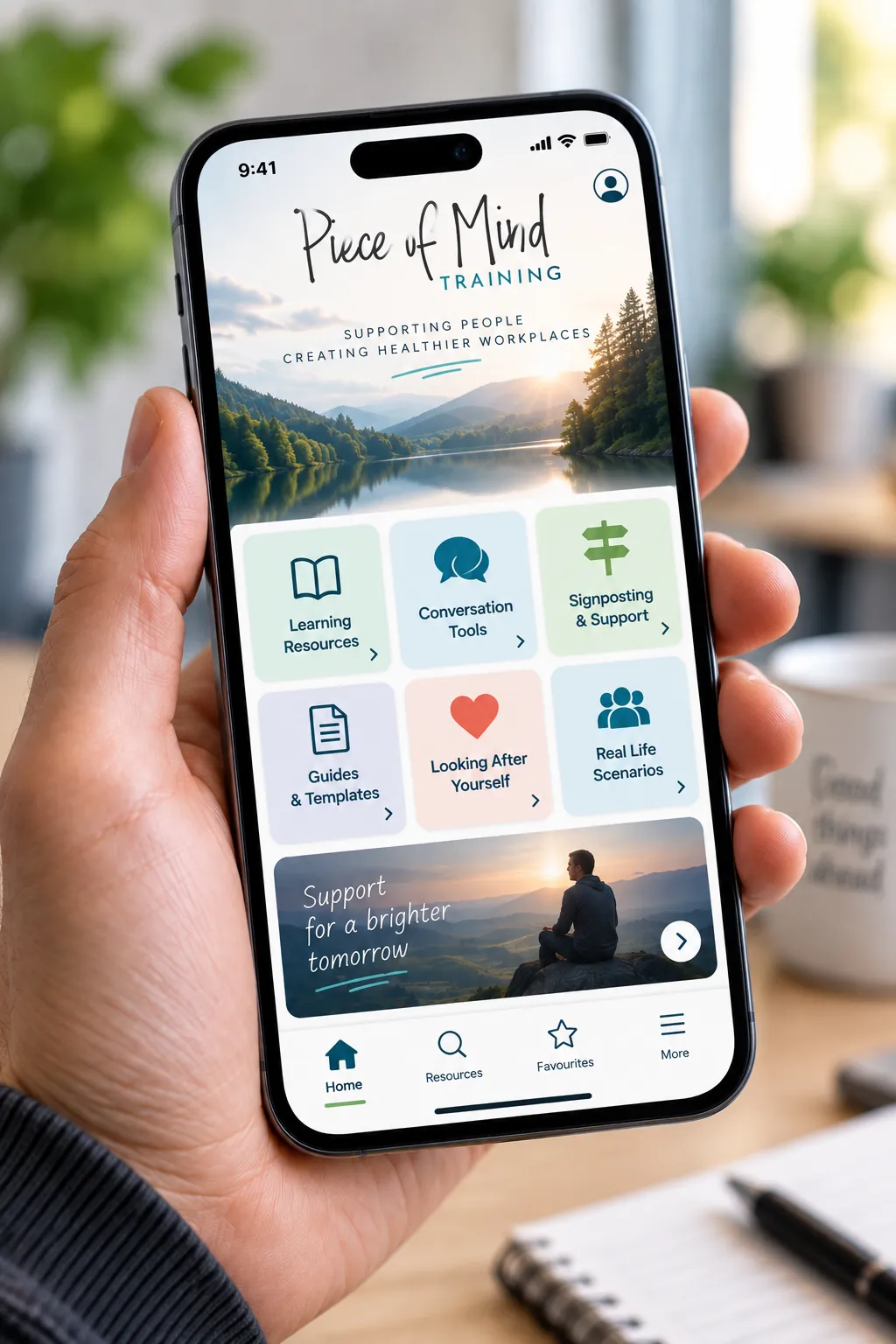 The Reach Out App home screen held in one hand