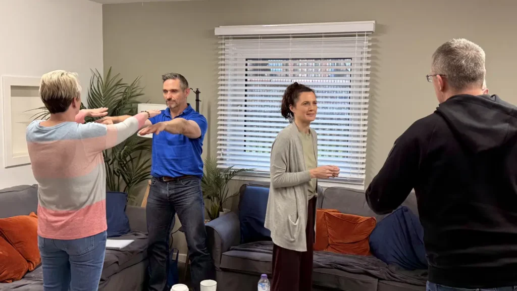 Hypnotherapy students practising techniques in pairs during a training weekend in Glasgow