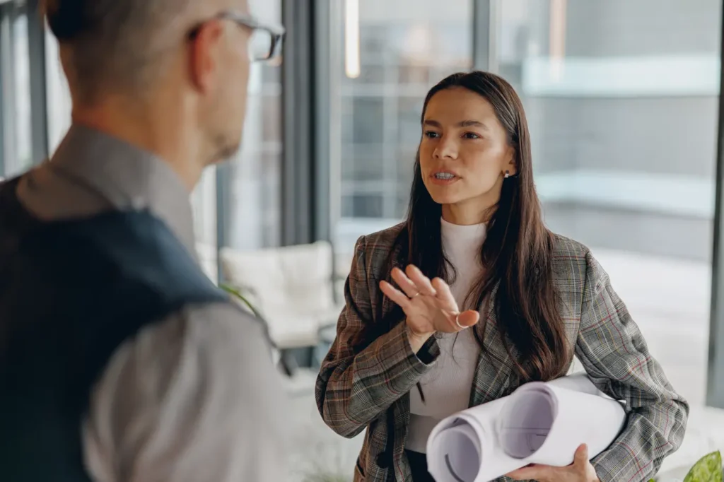 A manager and a team member talking face to face in the office